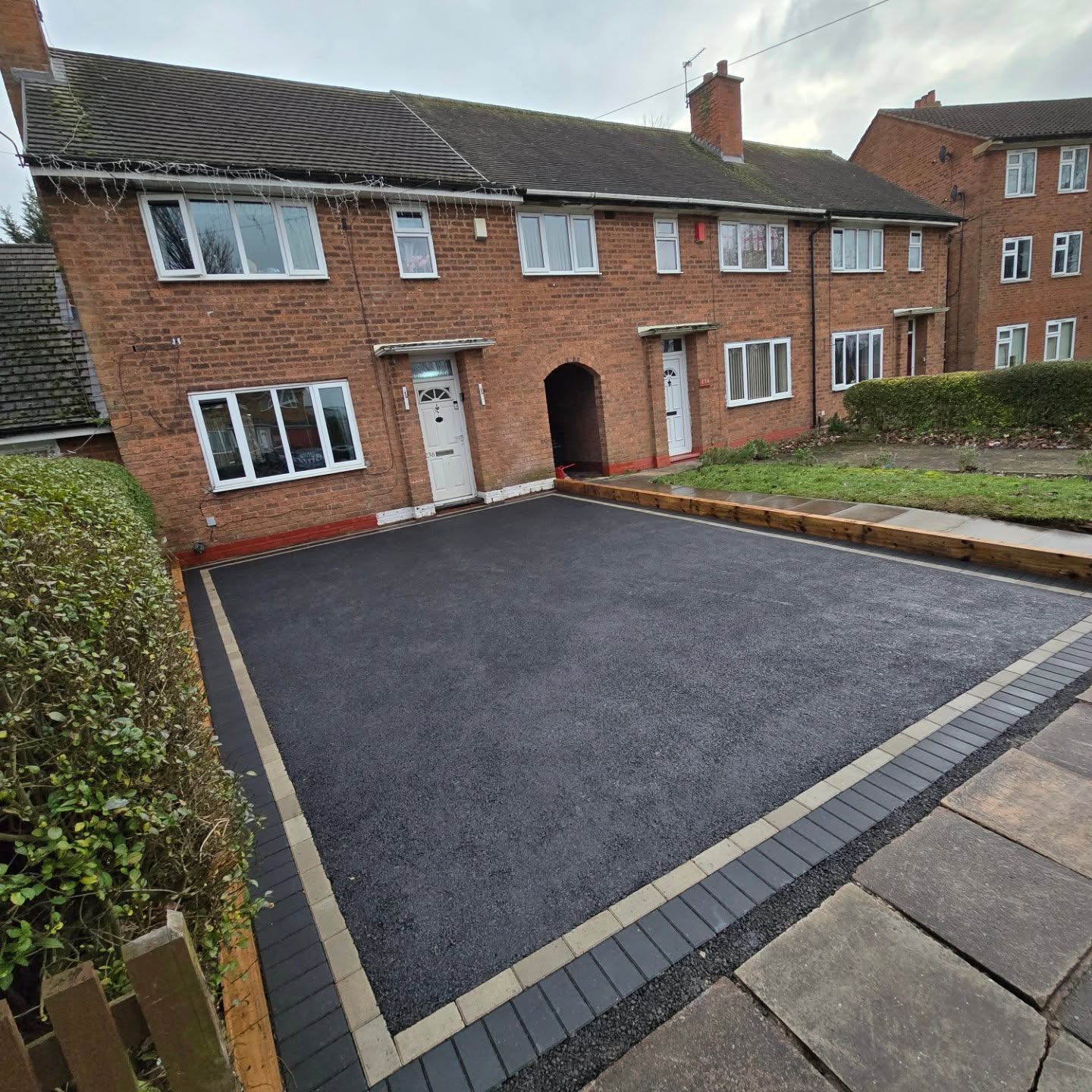 New tarmac driveway with block edging and a relaid access pathway